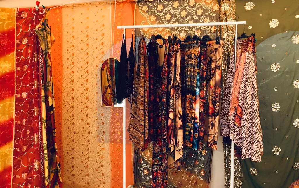 Kleiderstange mit farbigen Kleidern in der Home Boutique